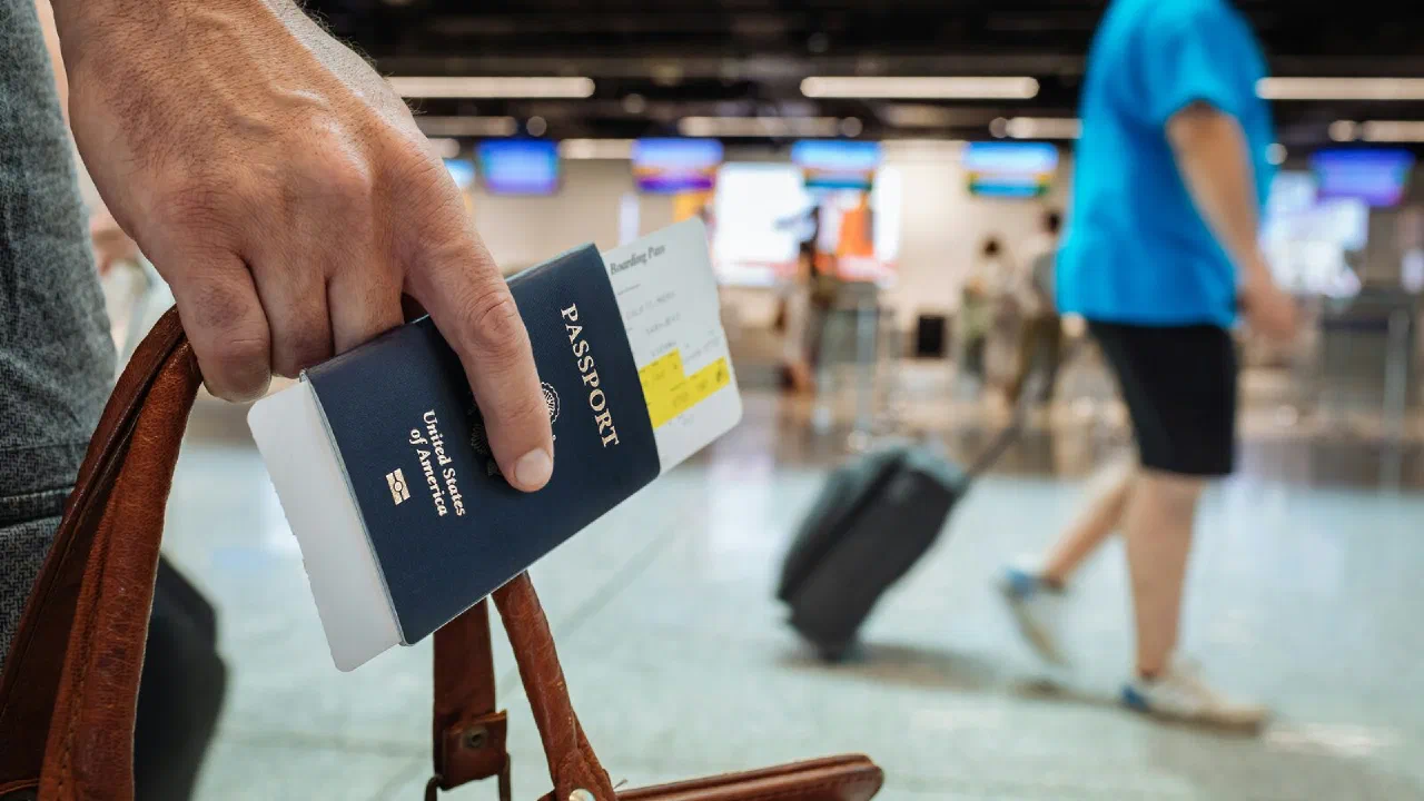 A hand holding a passport